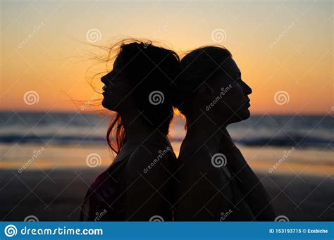 Close Up Silhouette Of Womens Couple In Romantic Scene Of Sunset Over The Sea Beautiful Female