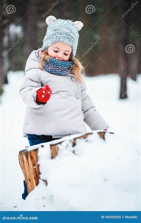 Cute Smiling Baby Girl Playing In Winter Snowy Forest Stock Image