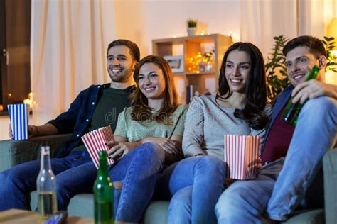 Friends With Beer And Popcorn Watching Tv At Home Stock Image Image