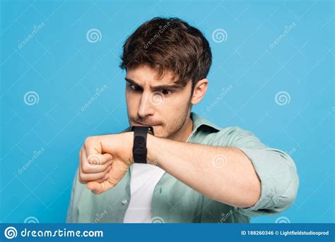Young Man Looking At Wristwatch Isolated Stock Photo Image Of