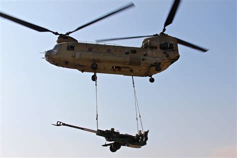A Ch 47 Chinook Helicopter Flies Off With An M777 Howitzer During