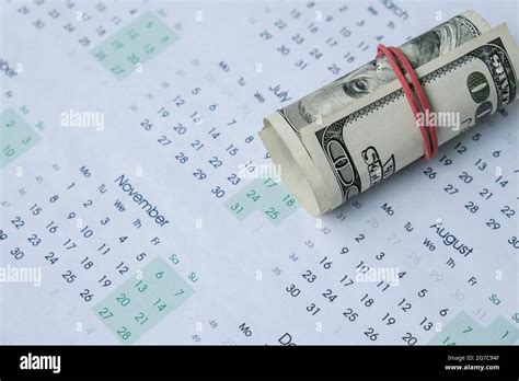 Office workplace desk with dollars and calendar. Counting money for