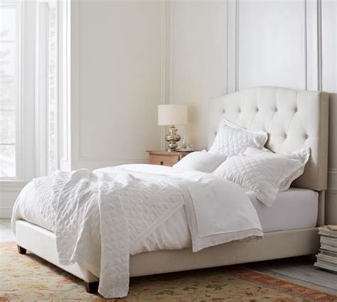 Pottery barn is known for their high end furniture, including their beds and bed frames. Elliot Curved Upholstered Bed | Pottery Barn