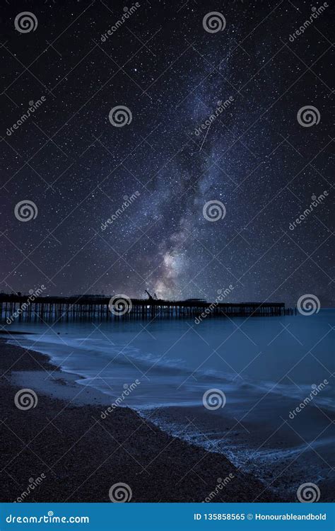 Vibrant Milky Way Composite Image Over Landscape Of Pier Under