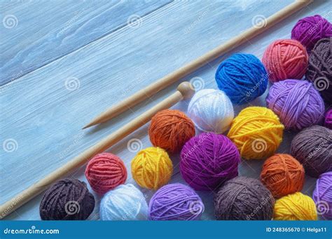 Colorful Balls Of Wool And Knitting Needles On Rustic Table Space For