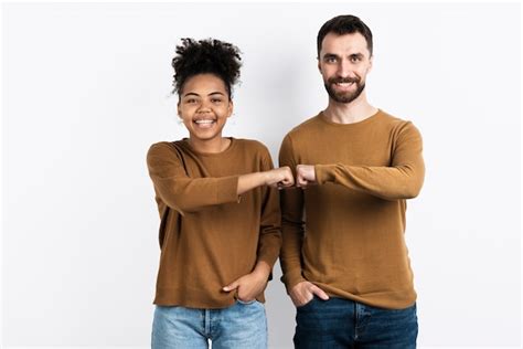 Free Photo Couple Posing While Fist Bumping