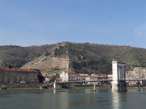 From middle english tein, teyne; Tournon and Tain-l'Hermitage on the Rhône River