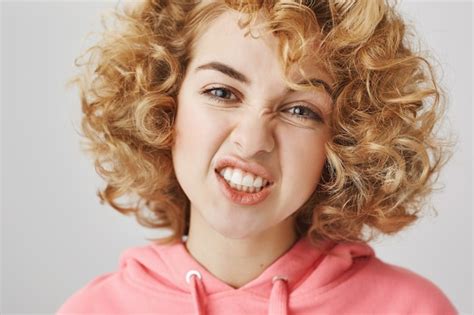 Close Up Of Sassy Happy Girl Showing Teeth Grimacing Free Photo