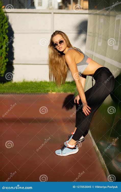amazing blonde girl wearing sunglasses and sport apparel posing stock image image of beautiful