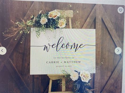 A Welcome Sign With Flowers On It In Front Of A Barn Door That Says Welcome