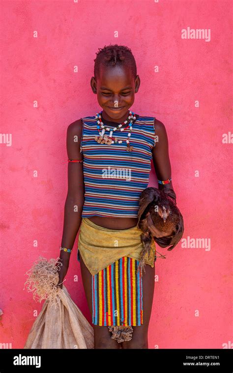A Child From The Banna Tribe In Traditional Costume On Her Way To