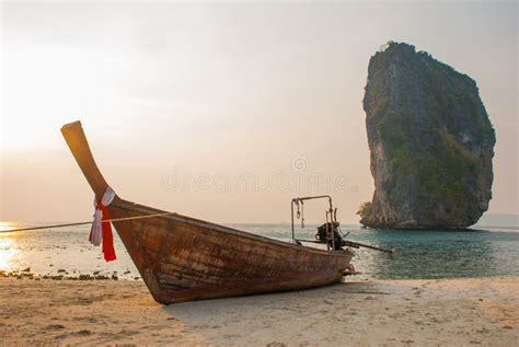 Long Tail Boat On Tropical Beach With Limestone Rock Sunset Island