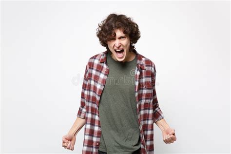 Portrait Of Angry Screaming Young Man In Casual Clothes Looking Camera