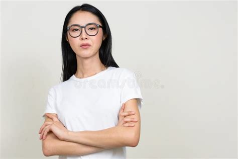 Young Beautiful Asian Nerd Woman Wearing Eyeglasses With Arms Crossed