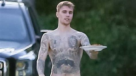 justin bieber goes shirtless and shows off his muscular tattooed body as wife hailey gushes over