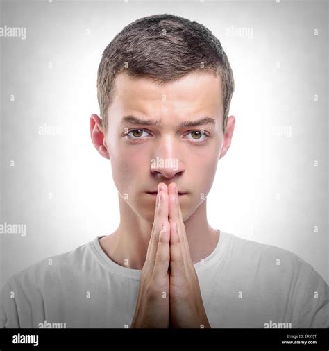 Young Man Praying Or Thinking Stock Photo Alamy