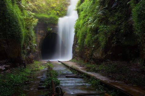 Waterfall Over The Entrance Of An Abandoned Tunnel After A Downpour