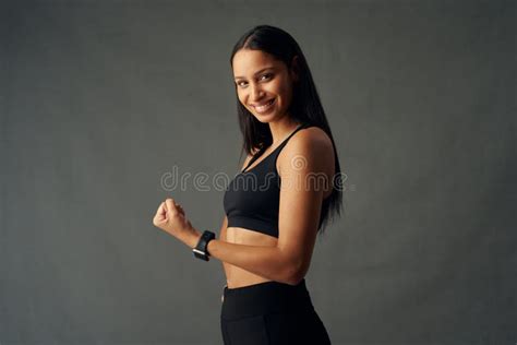 Young Biracial Woman Wearing Sports Bra And Fitness Tracker Smiling