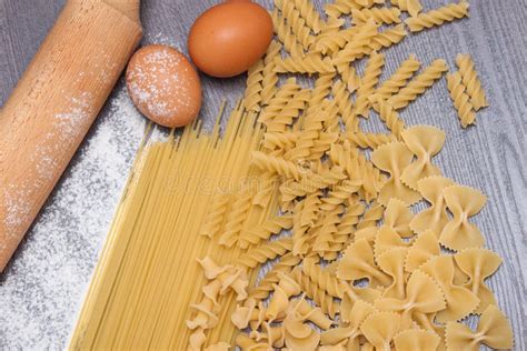 Various Types Or Raw Italian Pasta On The Wooden Rustic Background And