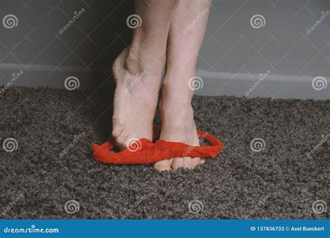 Red Thong Panties Around Ankles Of Unrecognizable Woman Stock Image