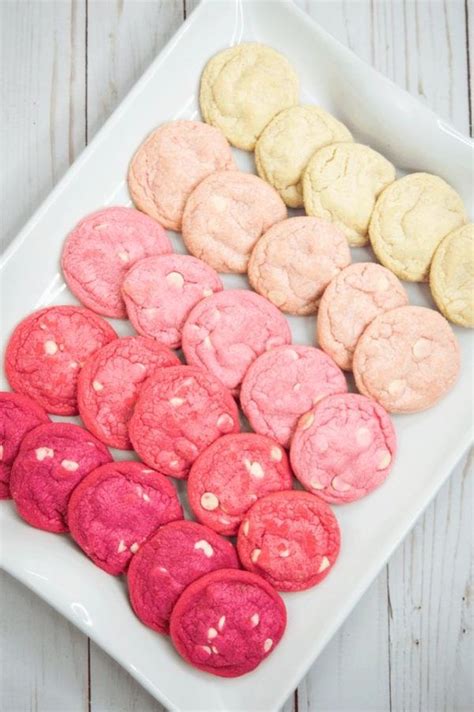 A White Plate Topped With Pink And Yellow Cookies