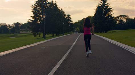 Woman Running In Slow Motion Running Woman On Park Road Sporty Woman Jogging Fitness Woman