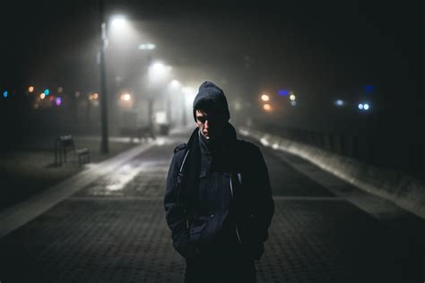Man Standing Near Street Lights Photo Free Light Image On Unsplash