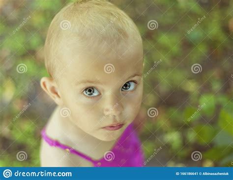 Close Up Portrait Of 3 Years Old Girl In Pink Summer Dress With Very