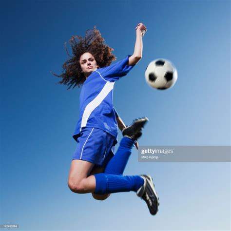Caucasian Woman Kicking Soccer Ball Stock Photo - Getty Images