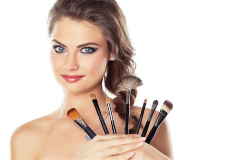 Premium Photo Beautiful Young Woman Holding Different Makeup Brushes