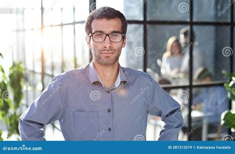 Young Businessman In Casual Clothes Stands With His Hands On His Waist