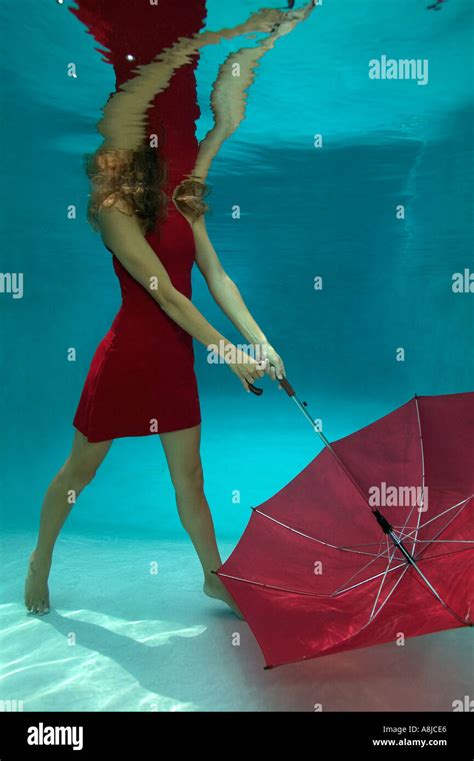 Woman In Red Dress With Umbrella Underwater In Pool Stock Photo Alamy