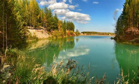 Turquoise Lake With Muddy Water Colorful Autumn Forest On The Shore