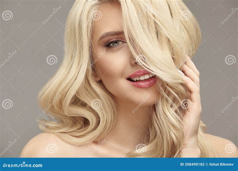 Nude Make Up And Natural Hairstyle Blonde Woman With Long Wavy Hair