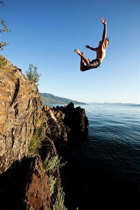 A Young Man Jumping Off A Cliff Photograph By Patrick Orton