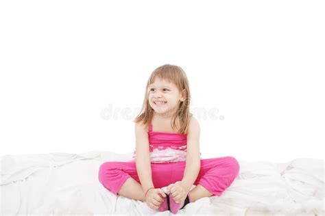 Cute Little Girl Sitting On The Bed Royalty Free Stock Photography