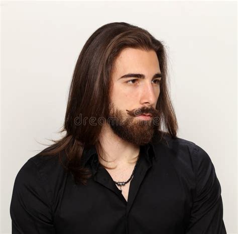 Young Fashionable Male Model With Long Hair And Beard Posing In Studio