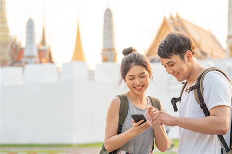 In thailand, the mobile phone is also a status symbol. Traveler Asian couple direction on location map in Bangkok ...