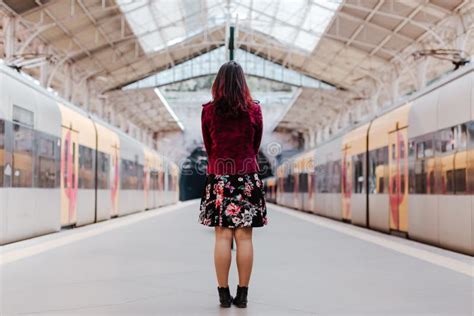 Back View Of Caucasian Woman In Train Station Waiting To Travel Travel And Lifestyle Concept