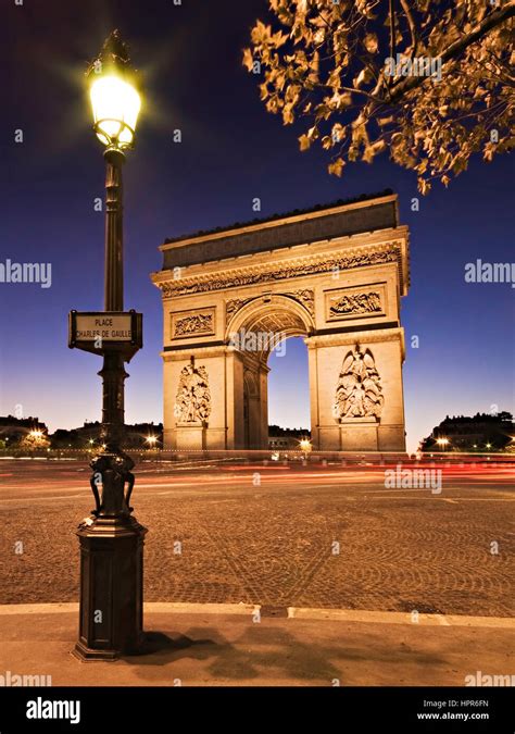 Night Time View Of The Arc De Triomphe In Paris France A Lamppost Is