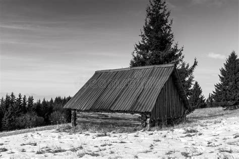 Small Abandoned Wood House At Wintertime On The Top Of The Mountain In