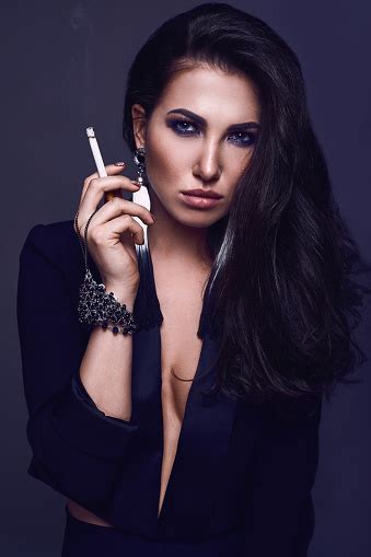 Elegant Hot Brunette Woman Smoking A Cigarette Stock Photo