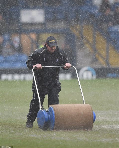 Working Hard A Groundsman Tries To Dry The Pitch At Bury But It Was