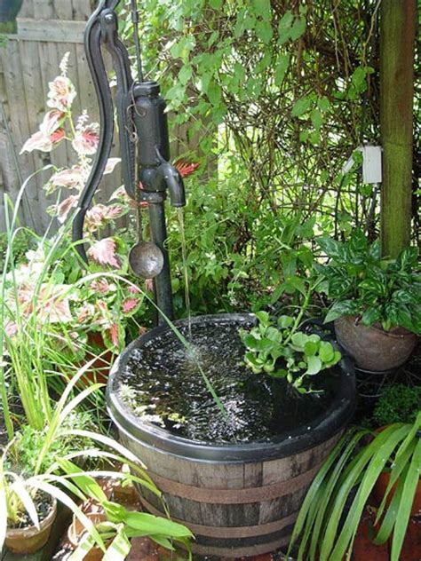 Homemade self water container raised garden using a water catchment system with a rain barrel for automatic watering system. Container water gardens • Preen