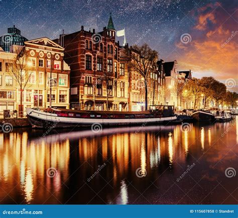 Beautiful Night In Amsterdam Night Illumination Of Buildings And Boats