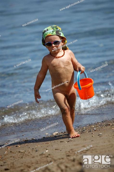 Boy Playing With Bucket On Beach Stock Photo Picture And Rights