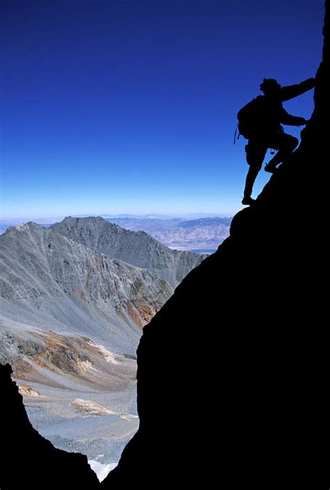 Man Climbing A Mountain At Dawn Ca Photograph By Justin Bailie