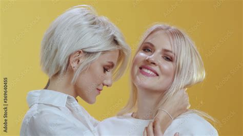 Nice Beautiful Lesbian Couple Of Lgbt Cute Blonde Girls Wearing White Shirts Embrace Each Other