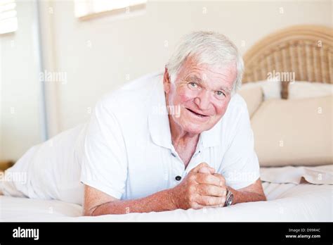 Happy Elderly Man Lying On Bed Stock Photo Alamy