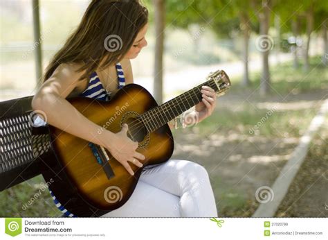 Beautiful Girl Playing A Guitar Royalty Free Stock Images